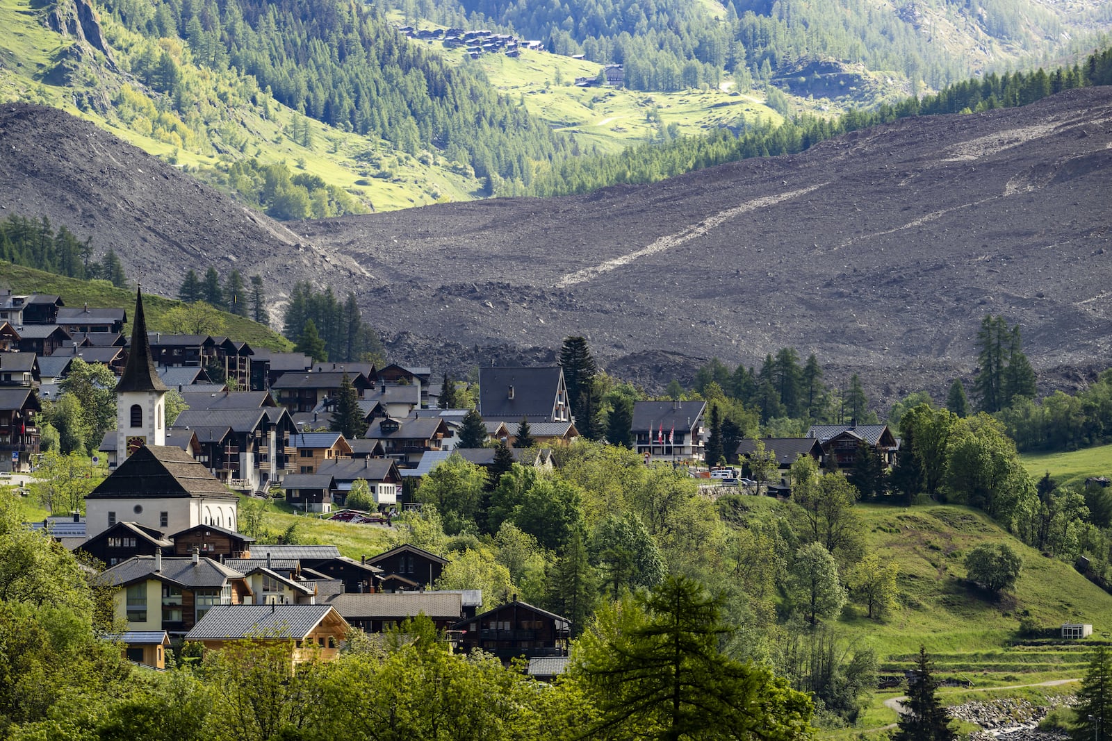 A massive debris avalanche, with the village of Kippel in the foreground, is seen on Thursday, May 29, 2025, one day after the collapse of the Birch Glacier causing the demolishing of the village of Blatten in Switzerland. (Jean-Christophe Bott/Keystone via AP)