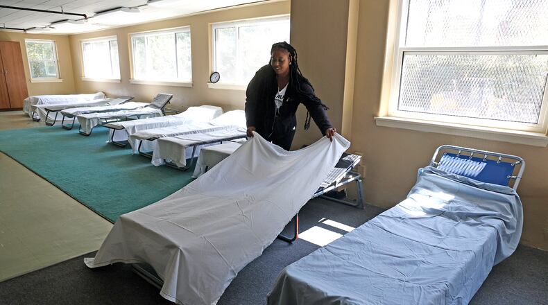 Taylor Cobb makes the beds Tuesday, Sept. 5, 2023 as she helps get Norm's Place homeless shelter ready to reopen. BILL LACKEY/STAFF