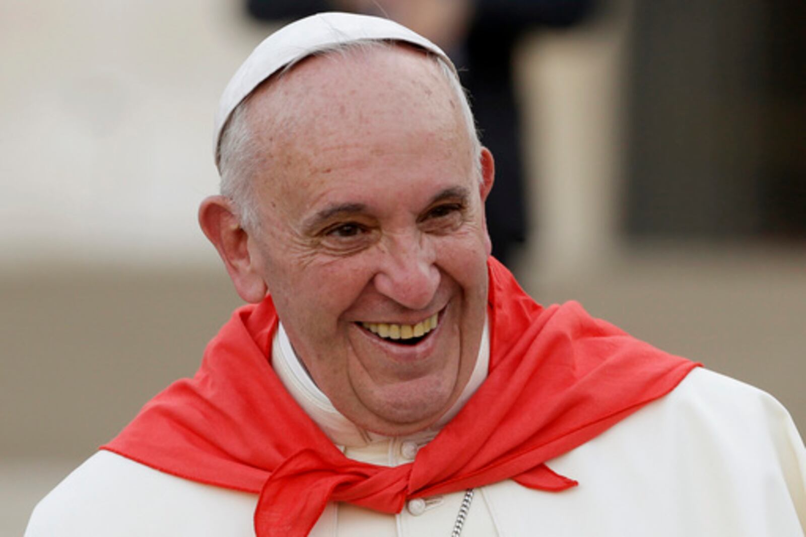 FILE - Pope Francis wears a red scarf as he smiles while leaving St. Peter's Square at the Vatican after an audience with with Altar boys and girls, on Aug. 4, 2015. (AP Photo/Gregorio Borgia, file)