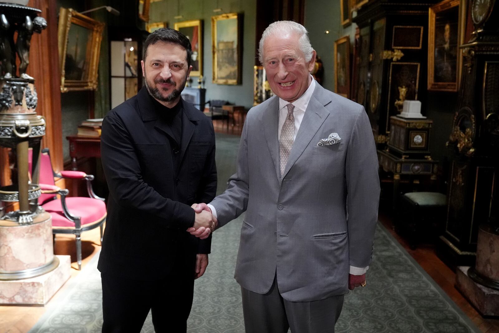 Britain's King Charles III, right, shakes hands with Ukrainian President Volodymyr Zelenskyy on the occasion of their private audience at Windsor Castle, England, Monday, June 23, 2025. (Jonathan Brady/Pool Photo via AP)