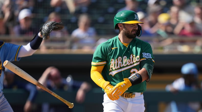 Athletics' Shea Langeliers flips his bat away after earning a walk against the Milwaukee Brewers during the third inning of a spring training baseball game Tuesday, Feb. 24, 2026, in Mesa, Ariz. (AP Photo/Ross D. Franklin)