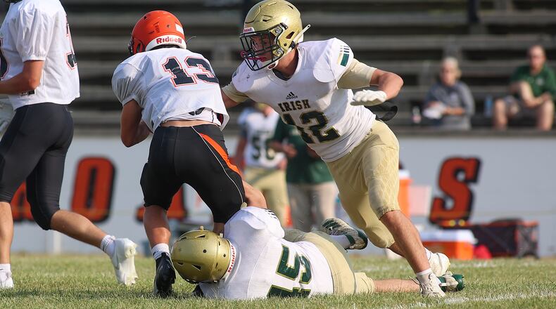 Cutline: Catholic Central High School senior Patrick Kavanaugh and junior Bryce Shipton bring down a Bradford player during their scrimmage last month at Bradford. CONTRIBUTED PHOTO BY MICHAEL COOPER