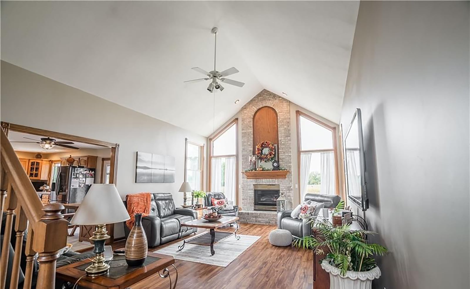 The two story great room has a floor to ceiling brick gas fireplace, ceiling fan, tile floors and tall windows overlooking the backyard. CONTRIBUTED