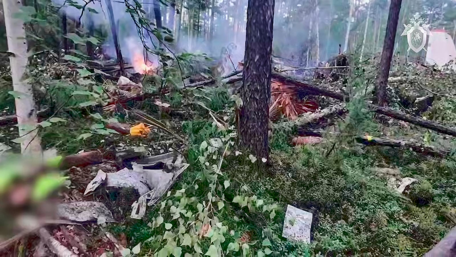 In this photo taken from video released by Russian Investigative Committee on Thursday, July 24, 2025, a view of the place of the crashed Russian An-24 passenger plane of the Siberia-based Angara Airlines while carrying 49 passengers in 15 kilometers (9 miles) south of Tynda, Far Eastern Amur region of Russia. (Russian Investigative Committee via AP)