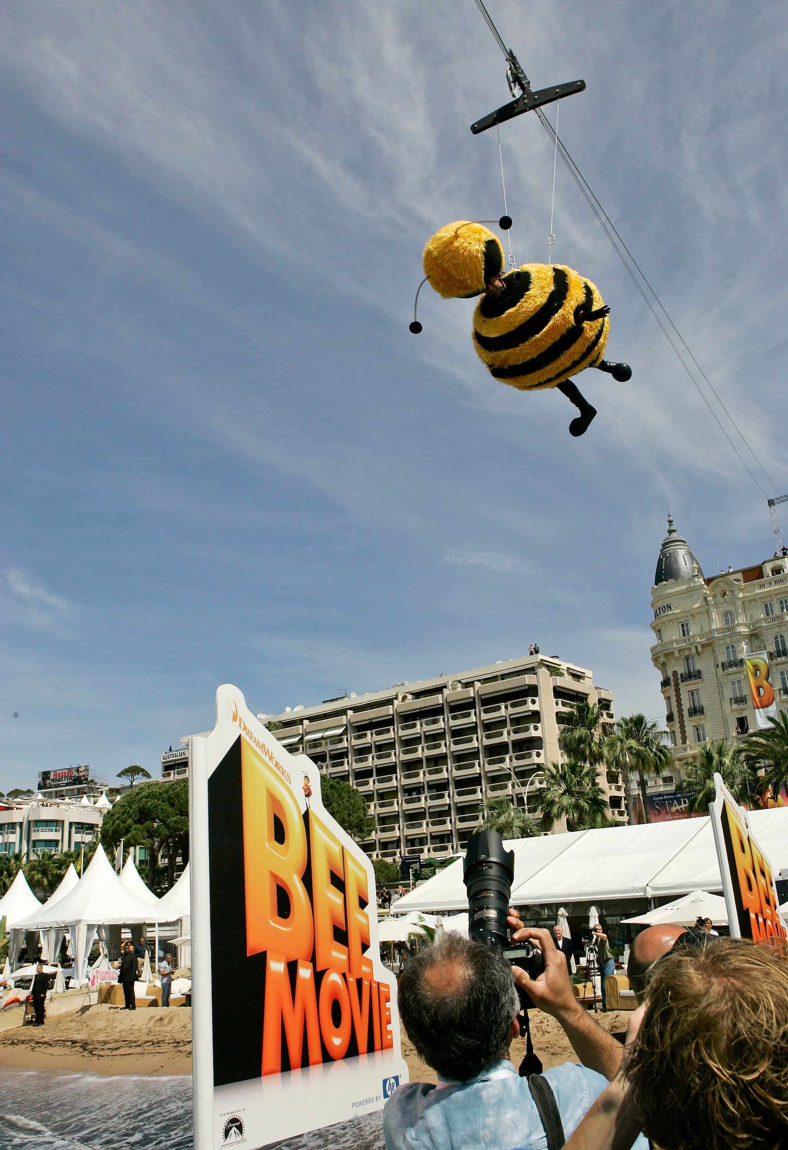 FILE - American comedian Jerry Seinfeld, dressed as a bee, glides through the air connected to a wire during a publicity stunt for the film "Bee Movie," at the 60th International film festival in Cannes, southern France, on Thursday, May 17, 2007. (AP Photo/Andrew Medichini, File)