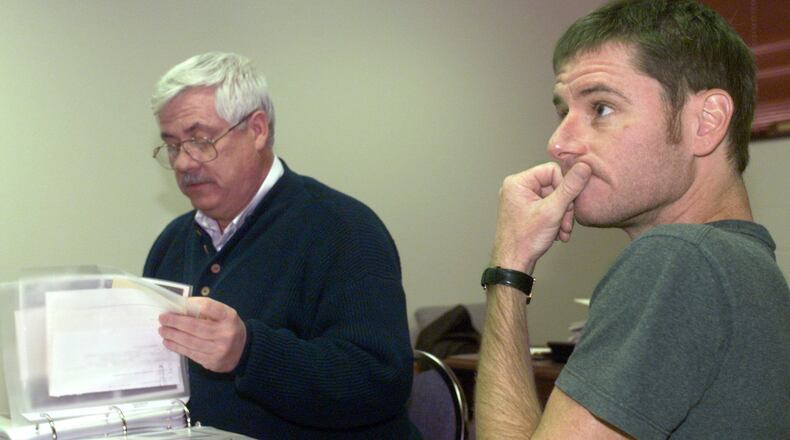 Michael Martin (right) goes over the evidence file on his mother’s homicide with Clark County Sheriff’s Lt. Patrick Sullivan in this file photo. The 1972 murder case remains unsolved.