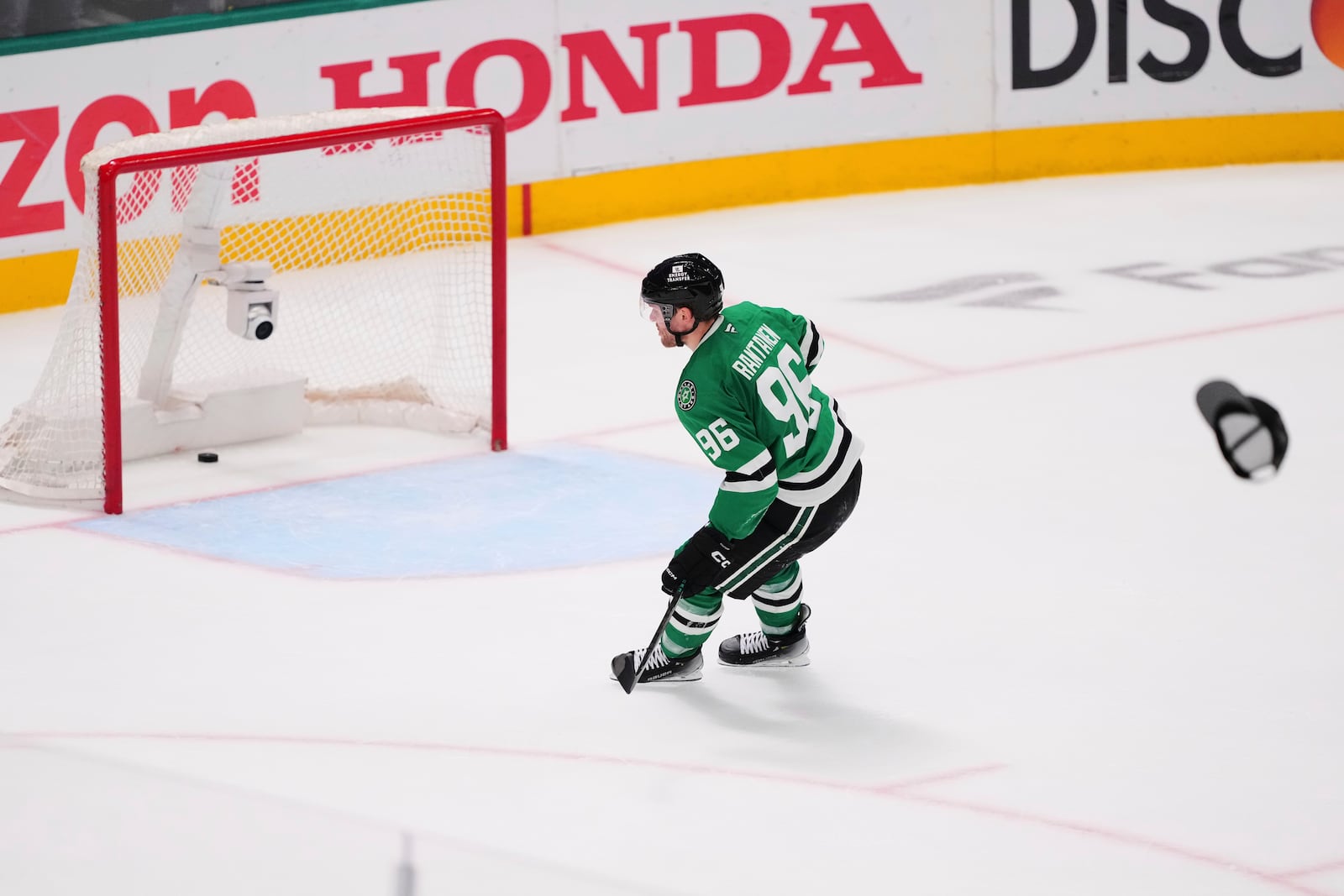 A hat is thrown onto the ice as Dallas Stars' Mikko Rantanen (96) scores an empty-net goal against to earn a hat trick in the third period in Game 7 of a first-round NHL hockey playoff series againts the Colorado Avalanche Saturday, May 3, 2025, in Dallas. (AP Photo/Julio Cortez)