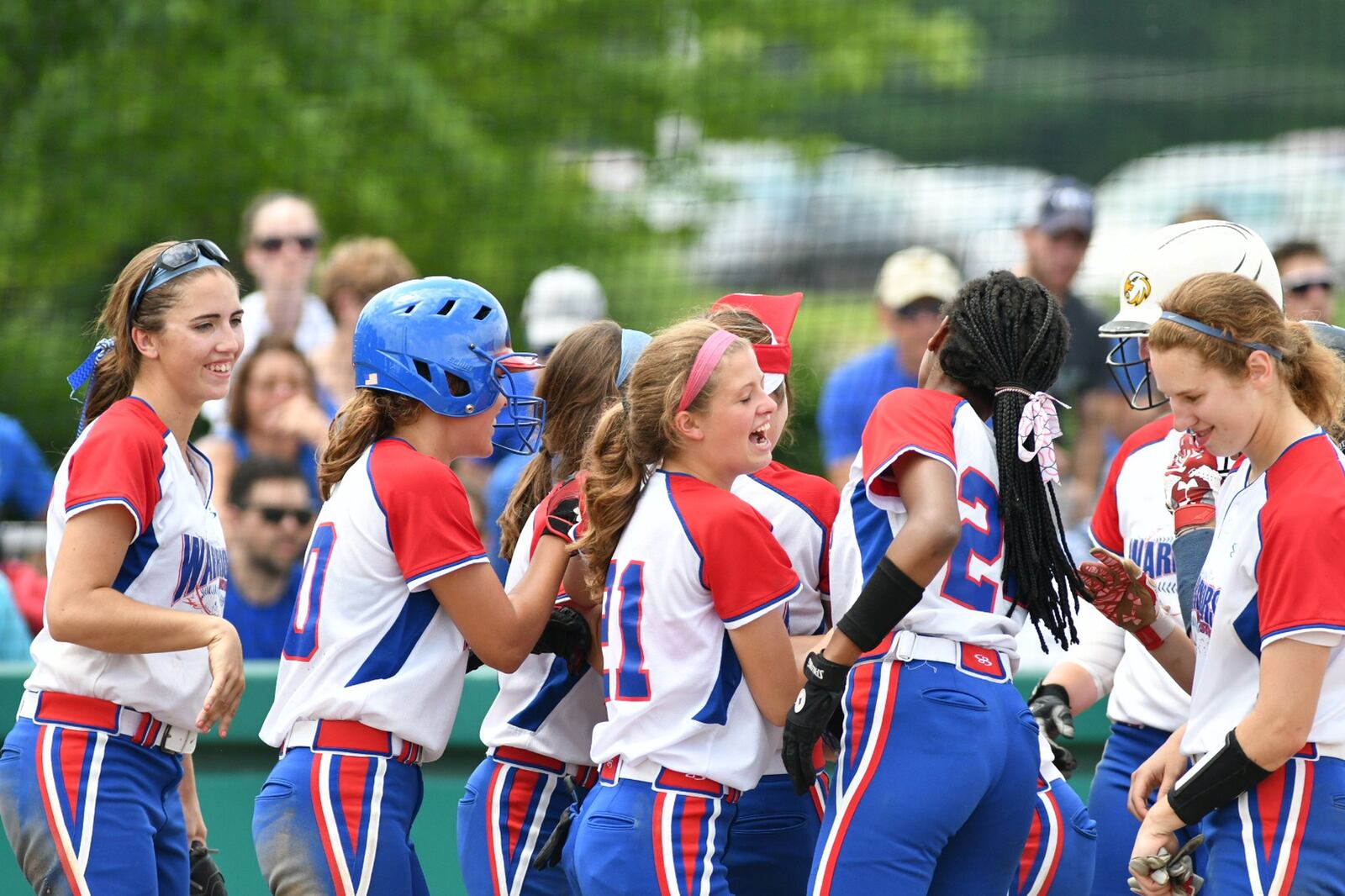 Northwestern softball players celebrate after Rachel Martin hit a home run in a regional final against Columbus Ready on Saturday at Wright State. BRYANT BILLING / CONTRIBUTED
