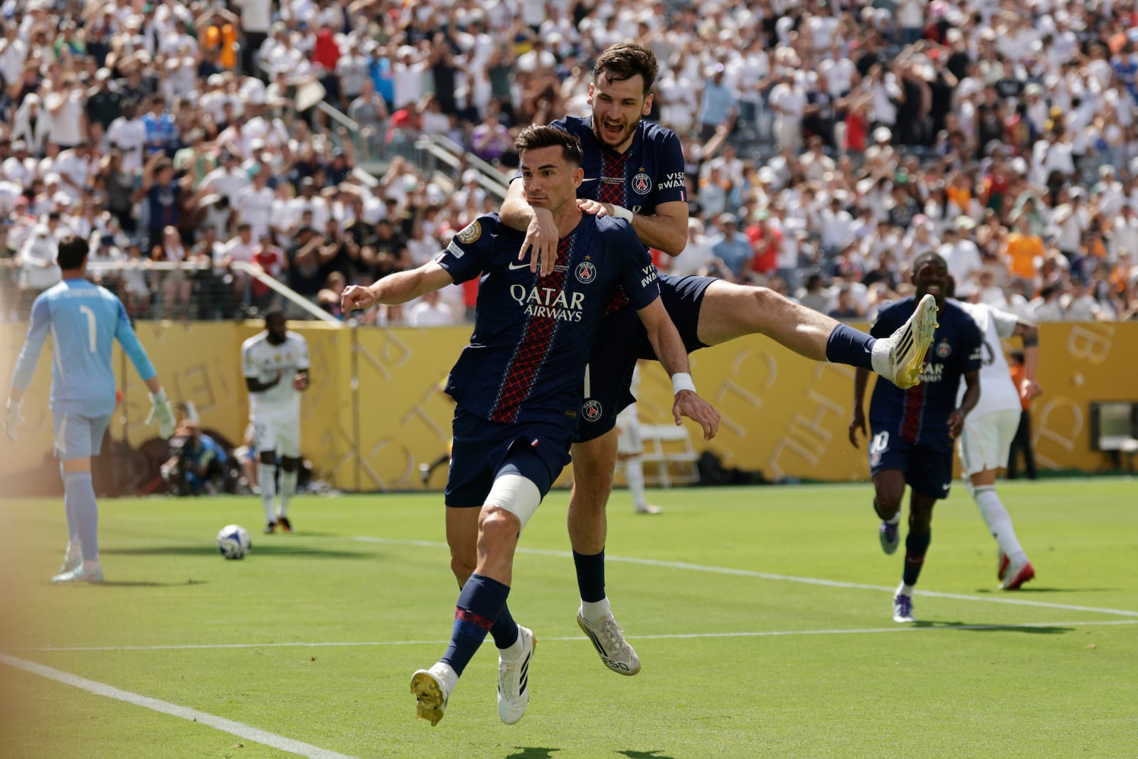 Paris Saint-Germain's Fabian Ruiz celebrates with team mate Khvicha Kvaratskhelia after scoring his side's opening goal during the Club World Cup semifinal soccer match between PSG and Real Madrid in East Rutherford, N.J., Wednesday, July 9, 2025. (AP Photo/Adam Hunger)