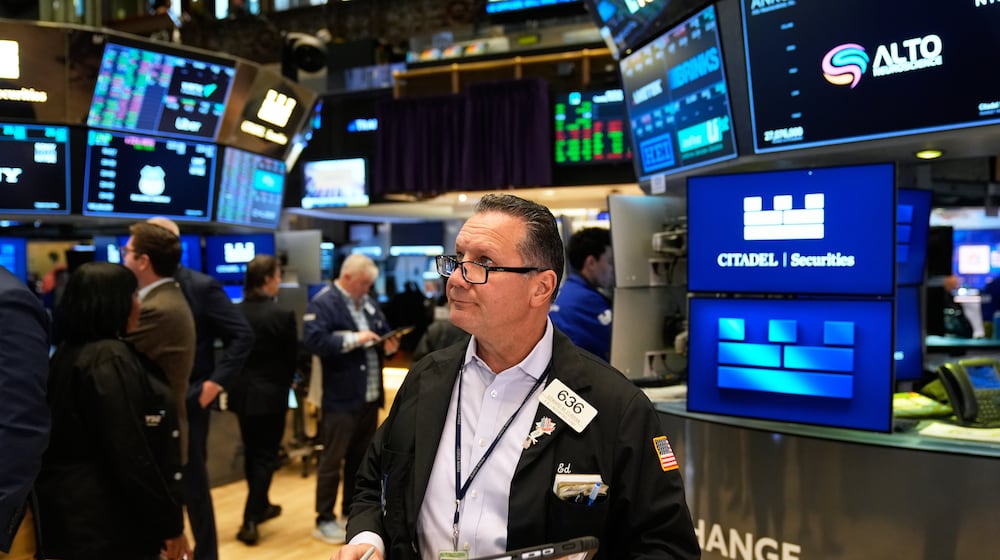 Edward Curran works on the floor at the New York Stock Exchange in New York, Tuesday, Nov. 11, 2025. (AP Photo/Seth Wenig)
