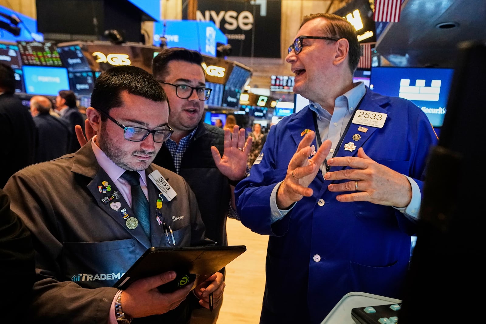 Traders Drew Cohen, left, and Joseph Lawler, center, work with specialist Patrick King on the floor of the New York Stock Exchange, Tuesday, June 10, 2025. (AP Photo/Richard Drew)