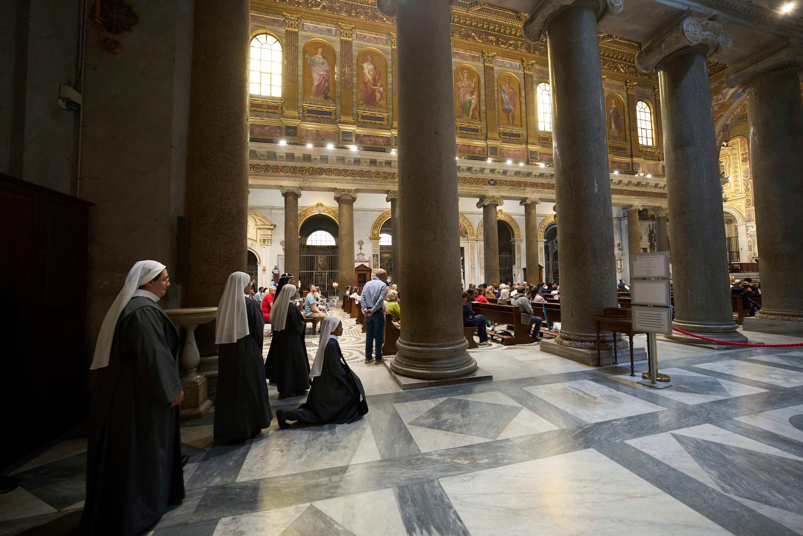 Nuns prays during a mass in Santa Maria in Trastevere church, in central Rome, Sunday, May 4, 2025. (AP Photo/Alessandra Tarantino)