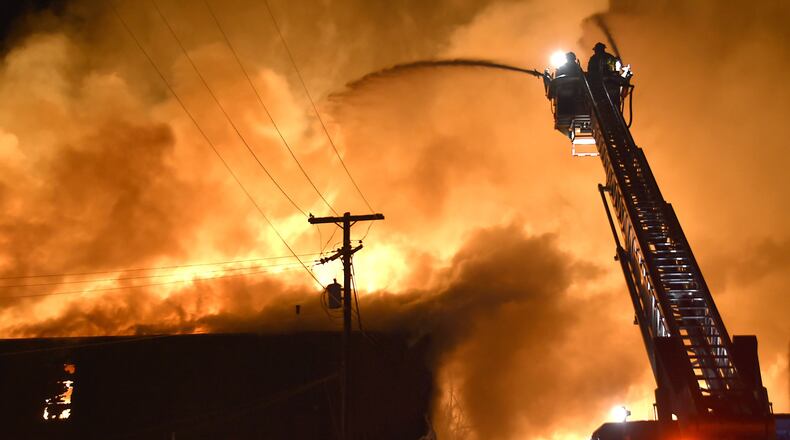 Members of the Springfield Fire Division battle a five alarm fire at Tri-State Pallet in downtown Springfield on Jan. 6, 2015. Bill Lackey/Staff