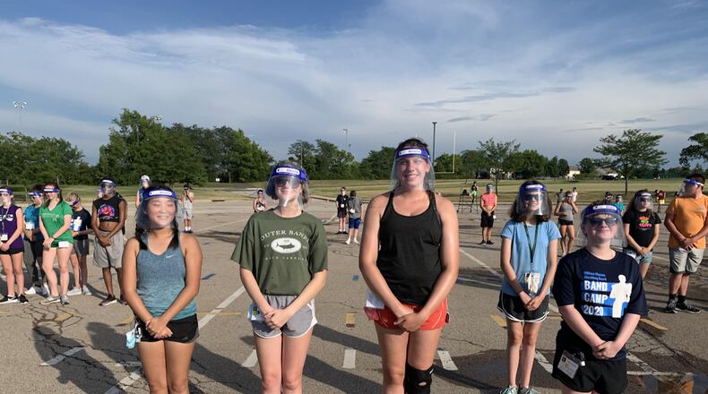 Area school officials say summer band and sports practices have been good testing sessions for students learning safe practices they will soon need as classes begin opening for the new school year. Pictured are Mason High School band members wearing face shields during practice. (Provided Photo\Journal-News)