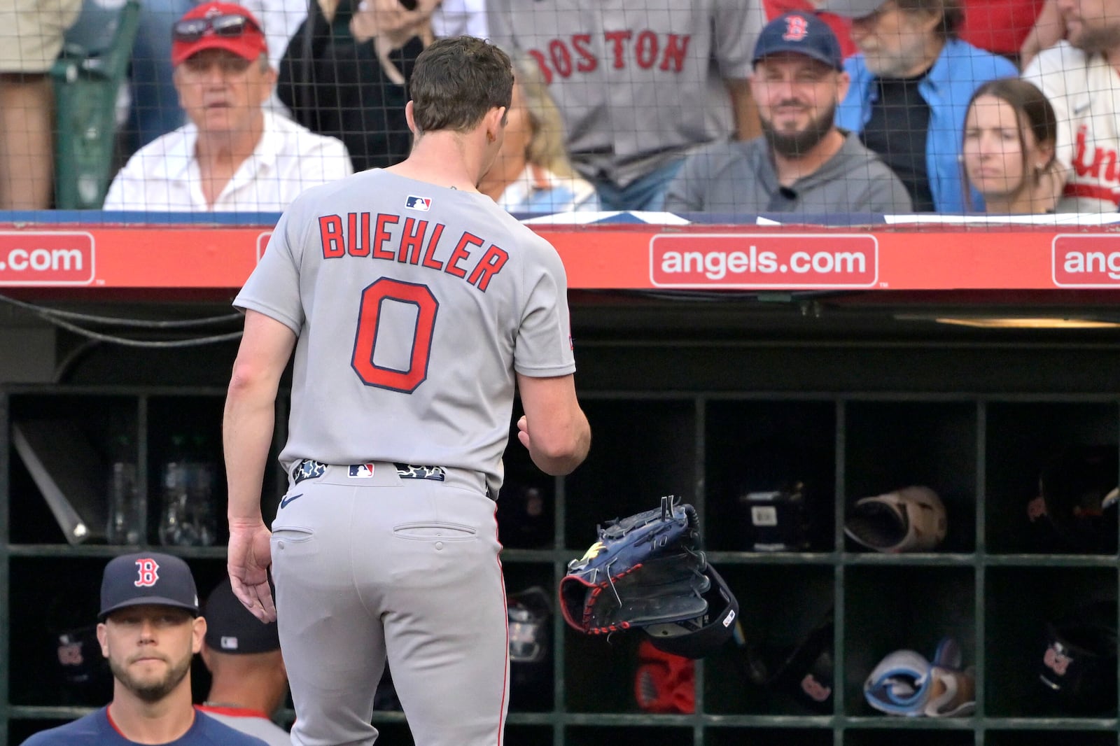 Boston Red Sox starting pitcher Walker Buehler (0) tosses his glove and cap into the dugout as he leaves the field after giving up five runs during the first inning of a baseball game against the Los Angeles Angels, Monday, June 23, 2025, in Anaheim, Calif. (AP Photo/Jayne Kamin-Oncea)