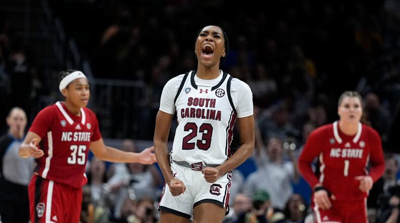 South Carolina guard Bree Hall (23) celebrates after making a three-point basket during the second half of a Final Four college basketball game against North Carolina State in the women's NCAA Tournament, Friday, April 5, 2024, in Cleveland. (AP Photo/Morry Gash)