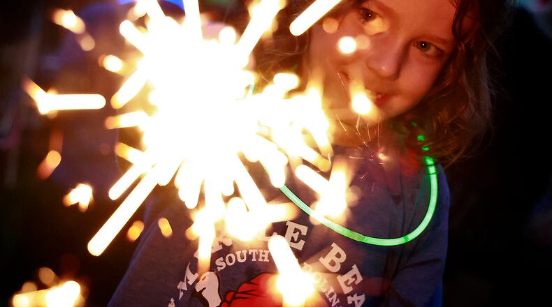 Rowan Irick, 4, plays with a sparkler Monday, July 3, 2023 at Ferncliff Cemetery before the Buck Creek Boom fireworks show. BILL LACKEY/STAFF