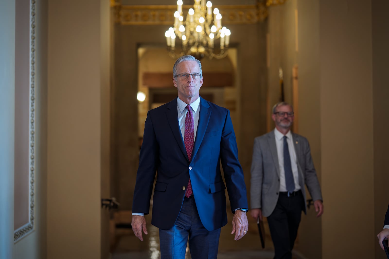 Senate Majority Leader John Thune, R-S.D., walks to the chamber as Senate Republicans work to pass President Donald Trump's big bill of tax breaks, spending cuts by his July Fourth deadline, at the Capitol in Washington, Sunday, June 29, 2025. (AP Photo/J. Scott Applewhite)
