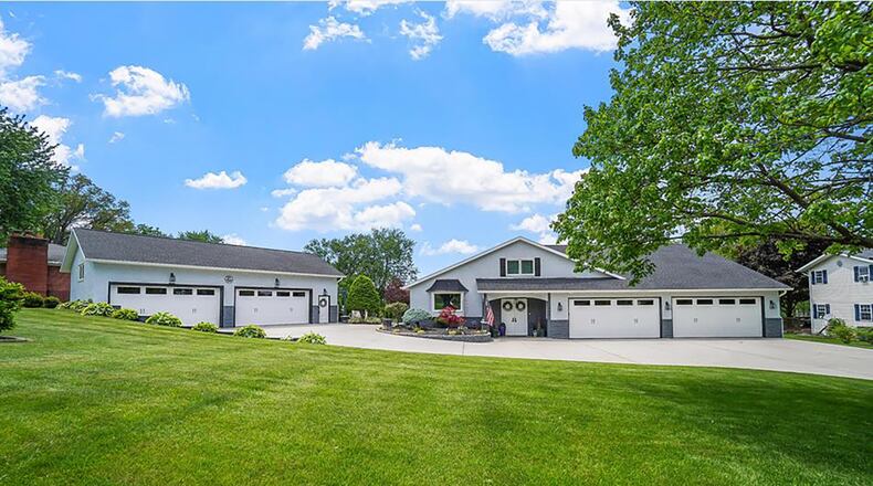 The front of the home has a concrete circular driveway and an attached four-car and detached four-car garage, both with new rubber flooring. CONTRIBUTED PHOTOS