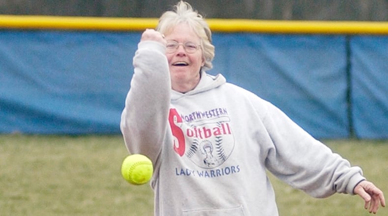 Northwestern legend Nancy Dutton throws the first pitch of Northwestern's softball season opener against Greeneview in 2006. News-Sun file photo