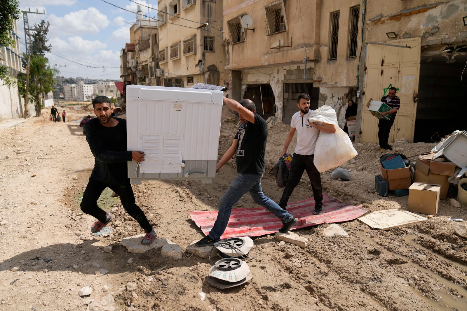 Residents of the now evacuated refugee camp of Tulkarem return to collect belongings before the destruction of their homes as Israeli forces prepare to carry out the demolition of 116 homes across the two refugee camps of the Israeli occupied West Bank city of Tulkarem, Friday, May 2, 2025. (AP Photo/Nasser Nasser)