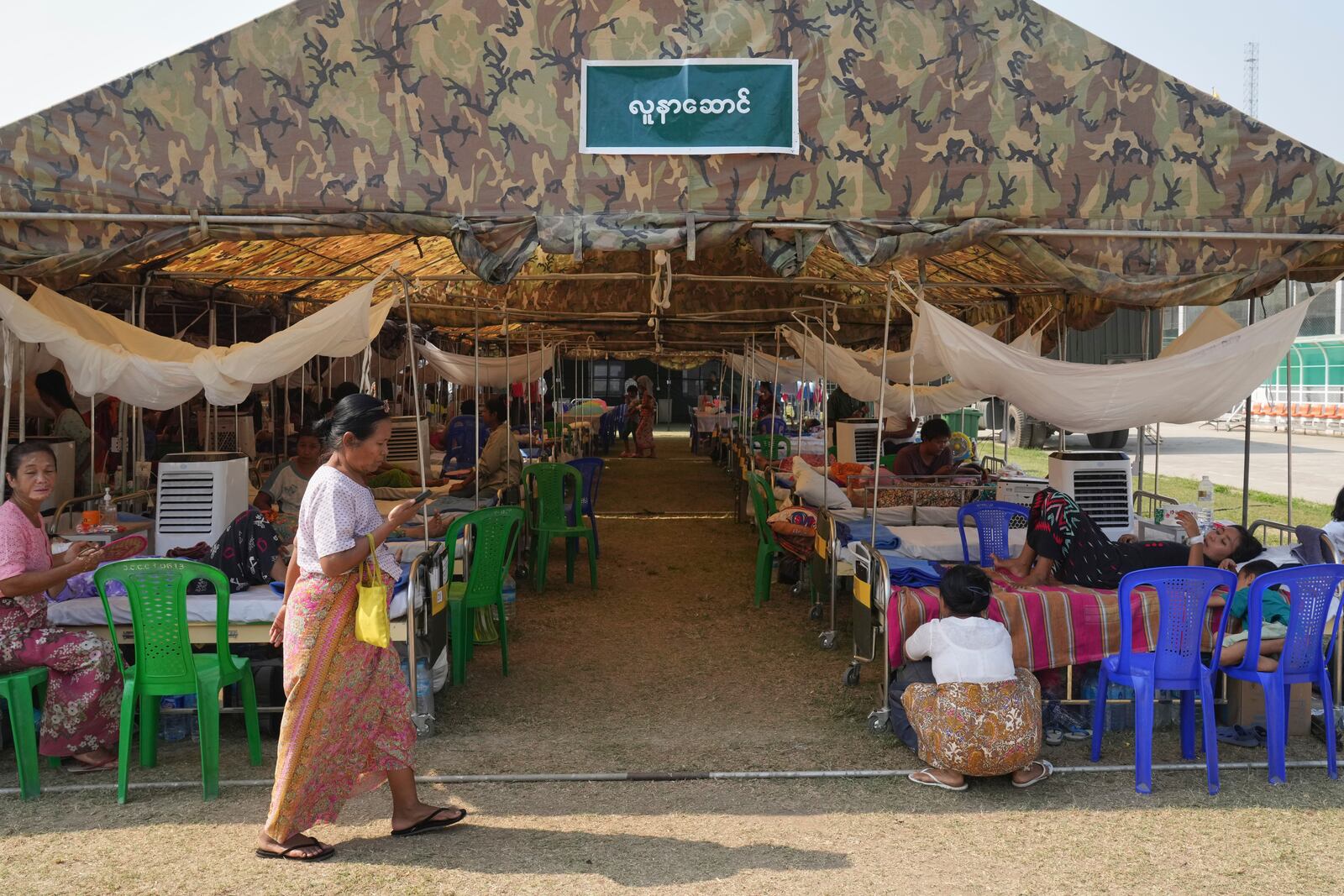 Patients are seen at a make-shift tent opened for medical care after last week's earthquake in Naypyitaw, Myanmar, Friday, April 4, 2025. (AP Photo)