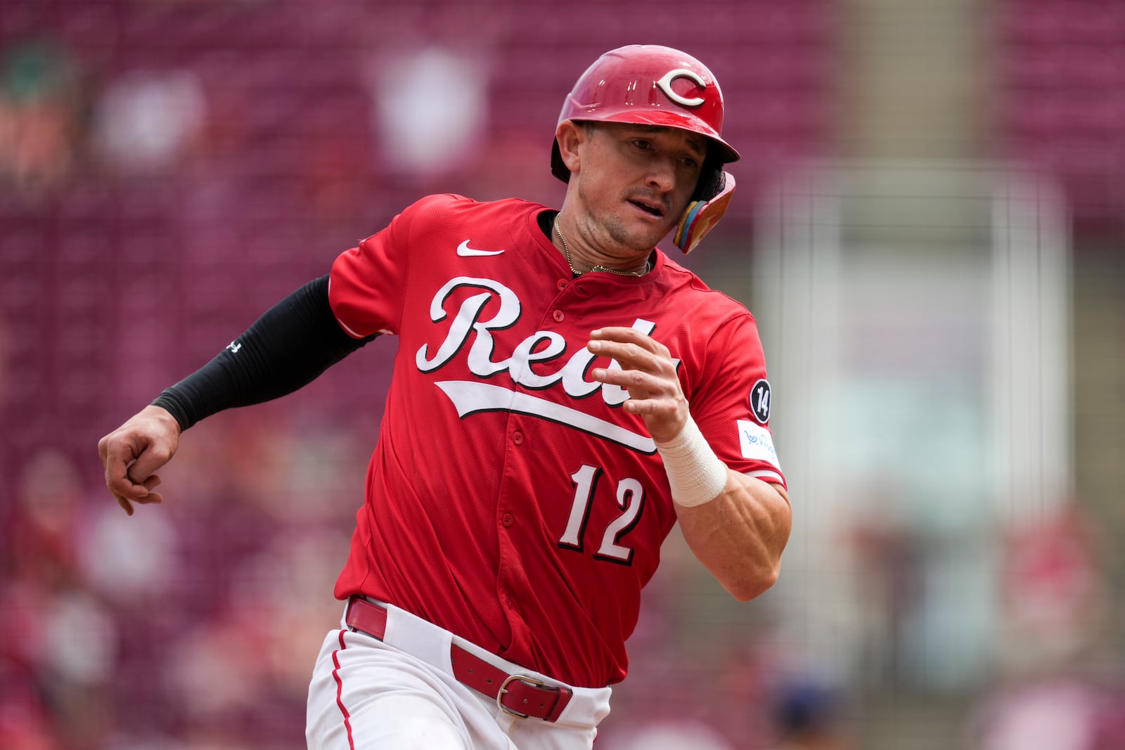 Cincinnati Reds' Austin Hays moves to third base after a hit by Cincinnati Reds' Noelvi Marte in the seventh inning of a baseball game against the Milwaukee Brewers, Sunday, Aug. 17, 2025, in Cincinnati. (AP Photo/Grace Bradley)