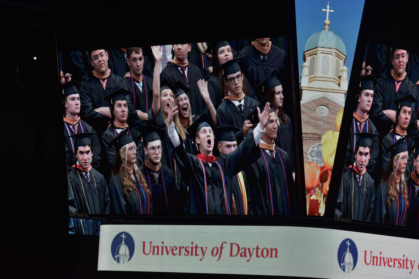 University of Dayton 2024 graduates celebrate during the undergraduate commencement on Sunday, May 5, 2024, on the jumbotron at UD Arena. SAM WILDOW\STAFF