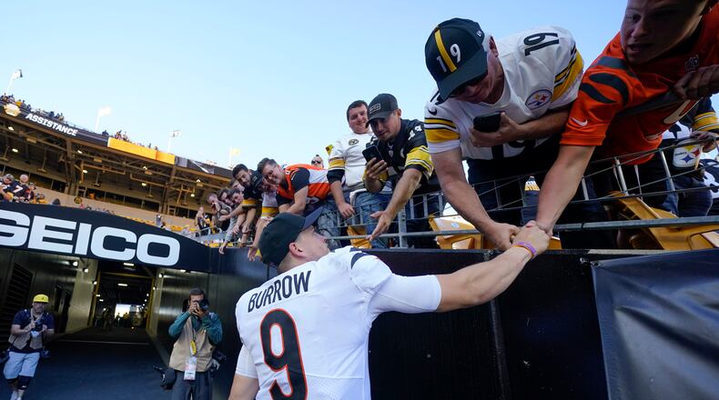 Cincinnati Bengals quarterback Joe Burrow (9) greets fans after defeating the Pittsburgh Steelers in an NFL football game, Sunday, Sept. 26, 2021, in Pittsburgh. The Bengals won 24-10. (AP Photo/Gene J. Puskar)
