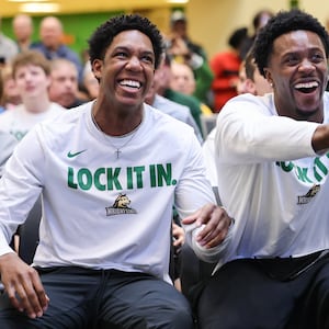 Wright State graduate senior guard Sam Alamutu (center) reacted to an opponent being announced for Gonzaga during a Selection Sunday watch party on Sunday, March 15 at the university's Student Union in Fairborn. BRYANT BILLING / STAFF