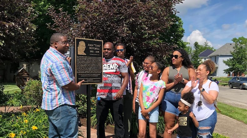 Family members of the late John "Tink" Mitchell unveil a plaque at a dedication ceremony opening Tink Memorial Park on Linden Ave. in Springfield on Saturday.