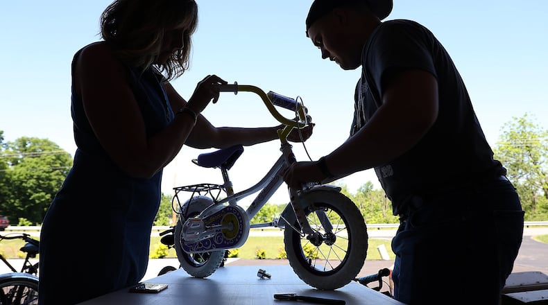 Bethel High School student volunteers assemble dontated bicycles for the Family and Youth Initiatives project called Dominic’s Bikes for Kids at the FYI office in New Carlisle in May. The project gives about 300 bikes to area kids in foster care. The bikes were scheduled to be distributed during the Family and Youth Initiatives’ Safety Day on June 12 at Tecumseh High School. The event was rescheduled to due to bad weather forecasts and will he held on Thursday, Aug. 2, 2018. Bill Lackey/Staff