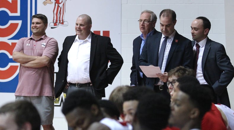 Wittenberg coaches watch the NCAC tournament trophy presentation after a victory against Ohio Wesleyan on Saturday, Feb. 24, 2018, at Pam Evans Smith Arena in Springfield. David Jablonski/Staff