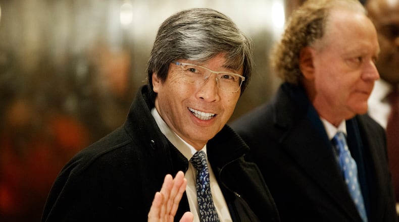 FILE - Pharmaceuticals billionaire Dr. Patrick Soon-Shiong waves as he arrives in the lobby of Trump Tower in New York for a meeting with President-elect Donald Trump on Jan. 10, 2017. (AP Photo/Evan Vucci, File)