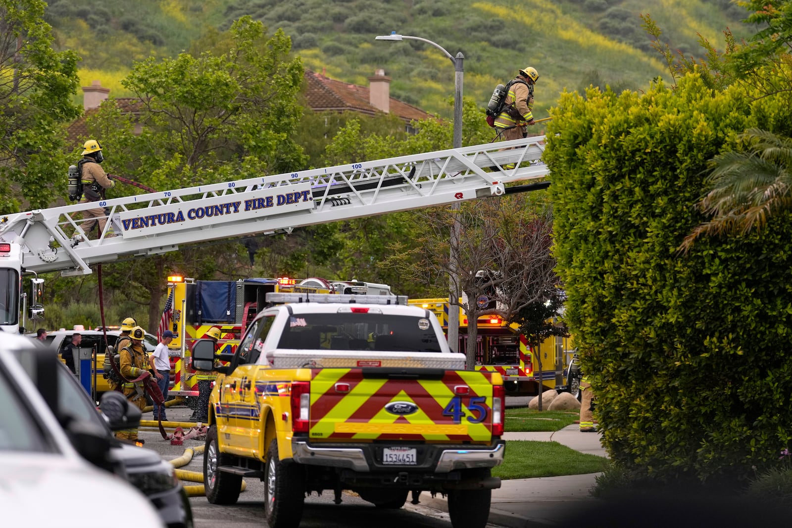 Firefighters work at the site of a plane crash in the Wood Ranch section of Simi Valley, Calif., on Saturday, May 3, 2025. (AP Photo/Mark J. Terrill)