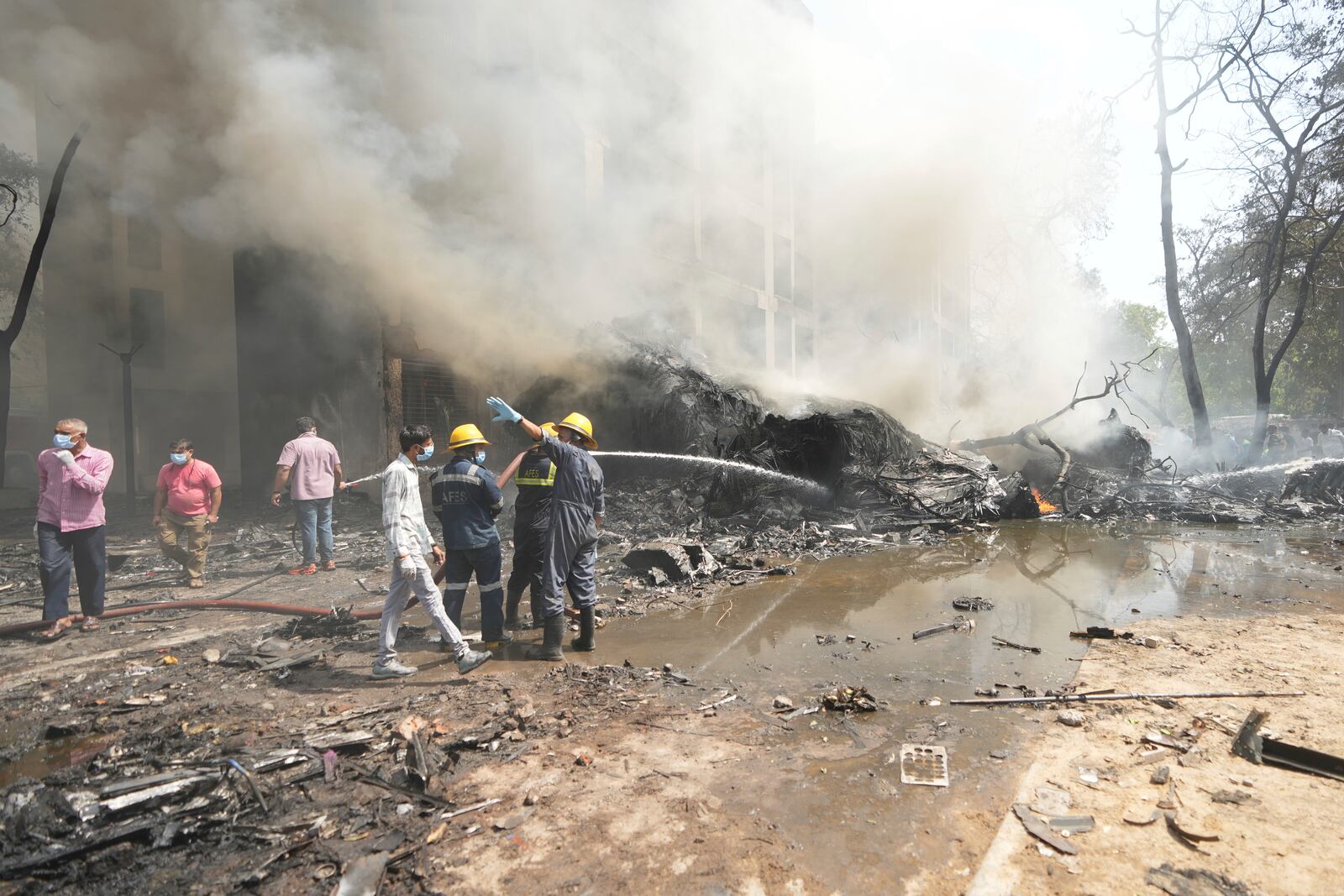 Firefighters work at the site of an airplane that crashed in India's northwestern city of Ahmedabad in Gujarat state, Thursday, June 12, 2025. (AP Photo/Ajit Solanki)
