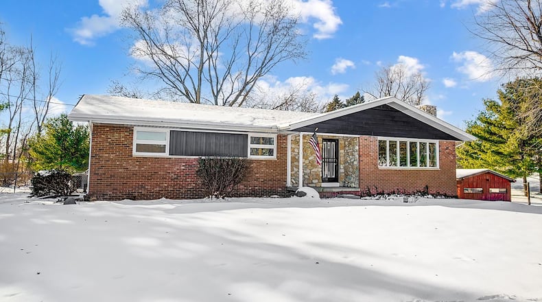 The brick and stone ranch has been completely remodeled and sits on a double lot.