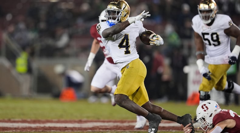 Notre Dame running back Jeremiyah Love (4) is tackled by Stanford safety Charlie Eckhardt (39) during the second half of an NCAA college football game, Saturday, Nov. 29, 2025, in Stanford, Calif. (AP Photo/Godofredo A. Vásquez)