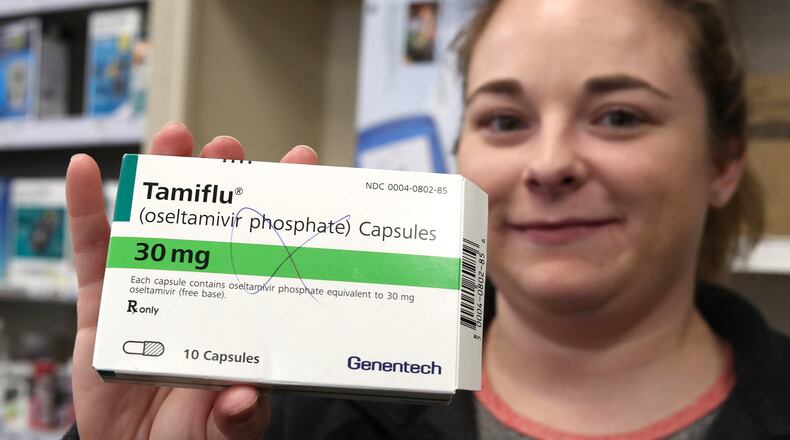 Dr. Ashley Sullivan, a pharmacist at Harding Road Pharmacy, holds up a box of Tamiflu. Bill Lackey/Staff
