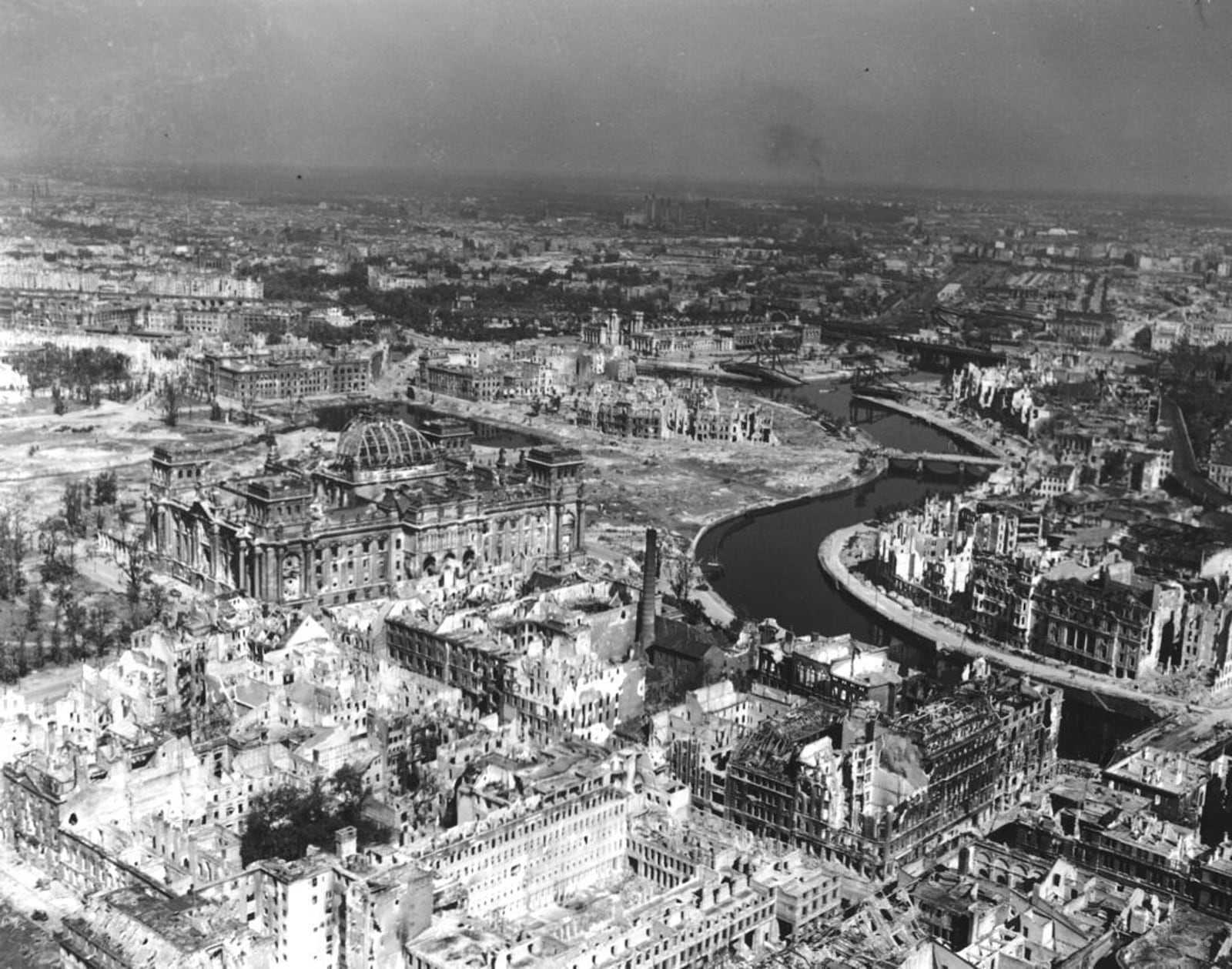FILE - A view taken from a Cub artillery observation plane on July 10, 1945, shows vast areas of destruction in Berlin, after repeated Anglo-American air raids on the German capital. Seen on the left, center, is the heavily damaged building of the German Reichstag with its distinct cupola, in the background center are the remains of Lehrter Bahnhof, one of the city's train stations. (AP Photo, File)
