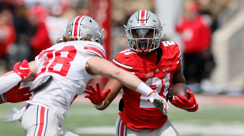 Ohio State running back Evan Pryor, right, runs after a catch as defensive back Cameron Kittle defends during an NCAA college spring football game Saturday, April 16, 2022, in Columbus, Ohio. (AP Photo/Jay LaPrete)