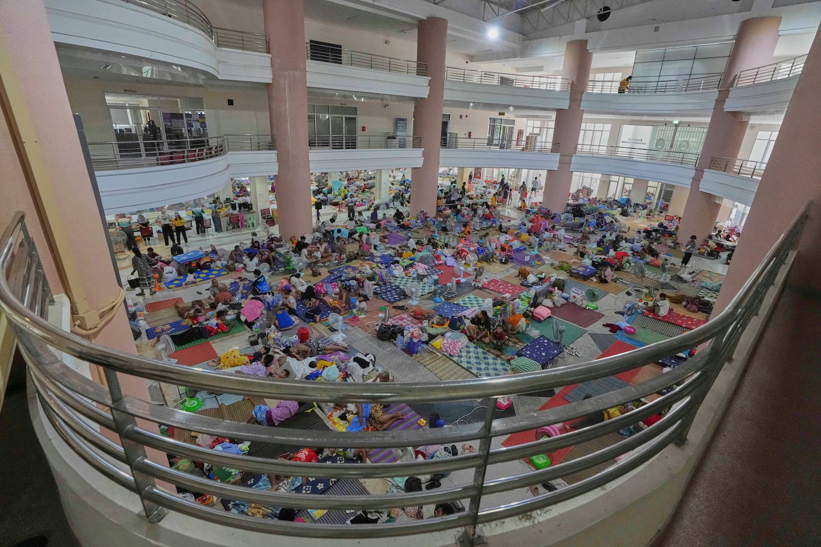Thai residents who fled homes following the clashes between Thai and Cambodian soldiers, rest at an evacuation center in Surin province, Thailand, Wednesday, July 30, 2025. (AP Photo/Sakchai Lalit)