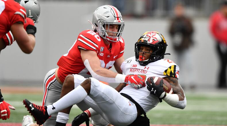 COLUMBUS, OH - NOVEMBER 9: Pete Werner #20 of the Ohio State Buckeyes tackles Javon Leake #20 of the Maryland Terrapins after a short gain in the second quarter at Ohio Stadium on November 9, 2019 in Columbus, Ohio. (Photo by Jamie Sabau/Getty Images)