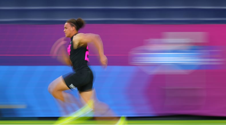 In this photograph taken with a slow shutter speed, Vanderbilt tight end Eli Stowers (25) runs the 40-yard dash at the NFL football scouting combine in Indianapolis, Friday, Feb. 27, 2026. (AP Photo/Julio Cortez)