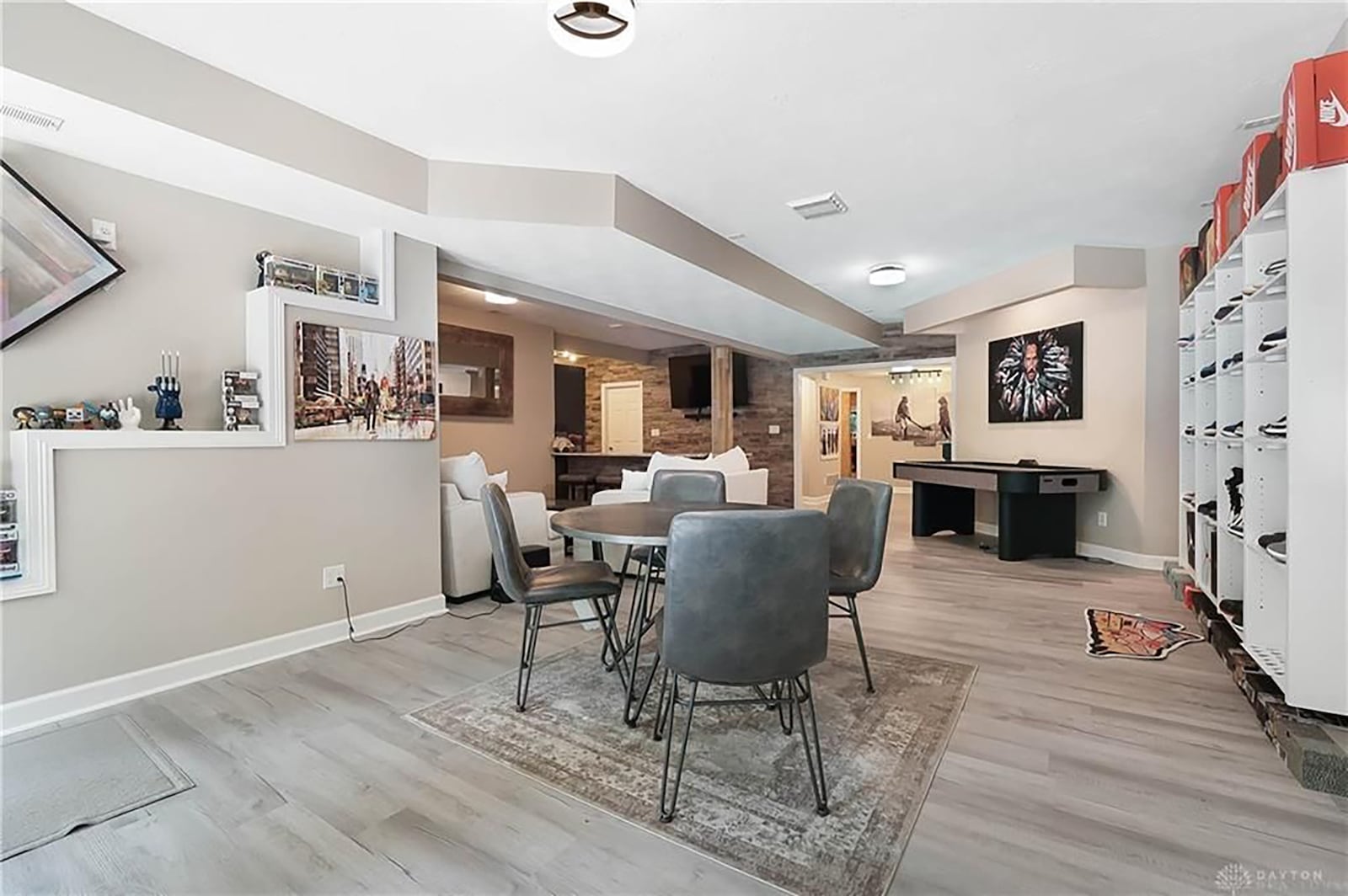 The walk out basement has LVT flooring and separate areas including a rec room and wet bar. There is a flex room/office on this level with wood floors and paneling. CONTRIBUTED