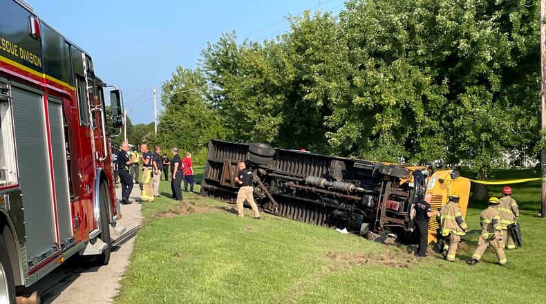 A Northwestern local schools bus with elementary schoolers inside flipped over in an accident involving another vehicle in the 4100 block of Troy Road (Ohio 41) at Lawrenceville near the German Twp. fire station on Tuesday, Aug. 22, 2023. BILL LACKEY/STAFF