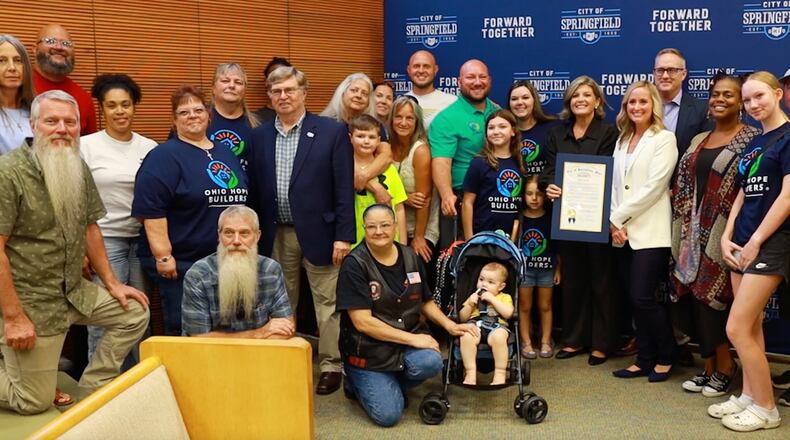 Ohio Hope Builders Founder and President Casey Tingley with his family, other members of the Ohio Hope Builders crew and members of the Springfield City Commission after the nonprofit receiving a proclamation from the city of Springfield celebrating the organization for a year of giving back and responding to natural disasters. CONTRIBUTED