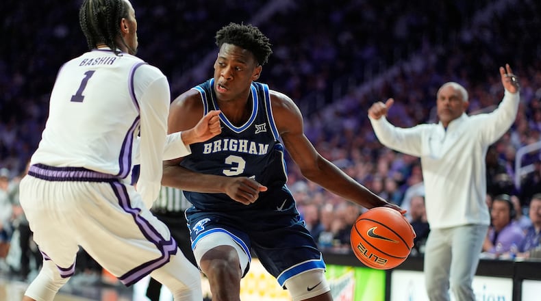 BYU forward AJ Dybantsa (3) looks to get past Kansas State guard Abdi Bashir Jr. (1) during the first half of an NCAA college basketball game Saturday, Jan. 3, 2026, in Manhattan, Kan. (AP Photo/Charlie Riedel)