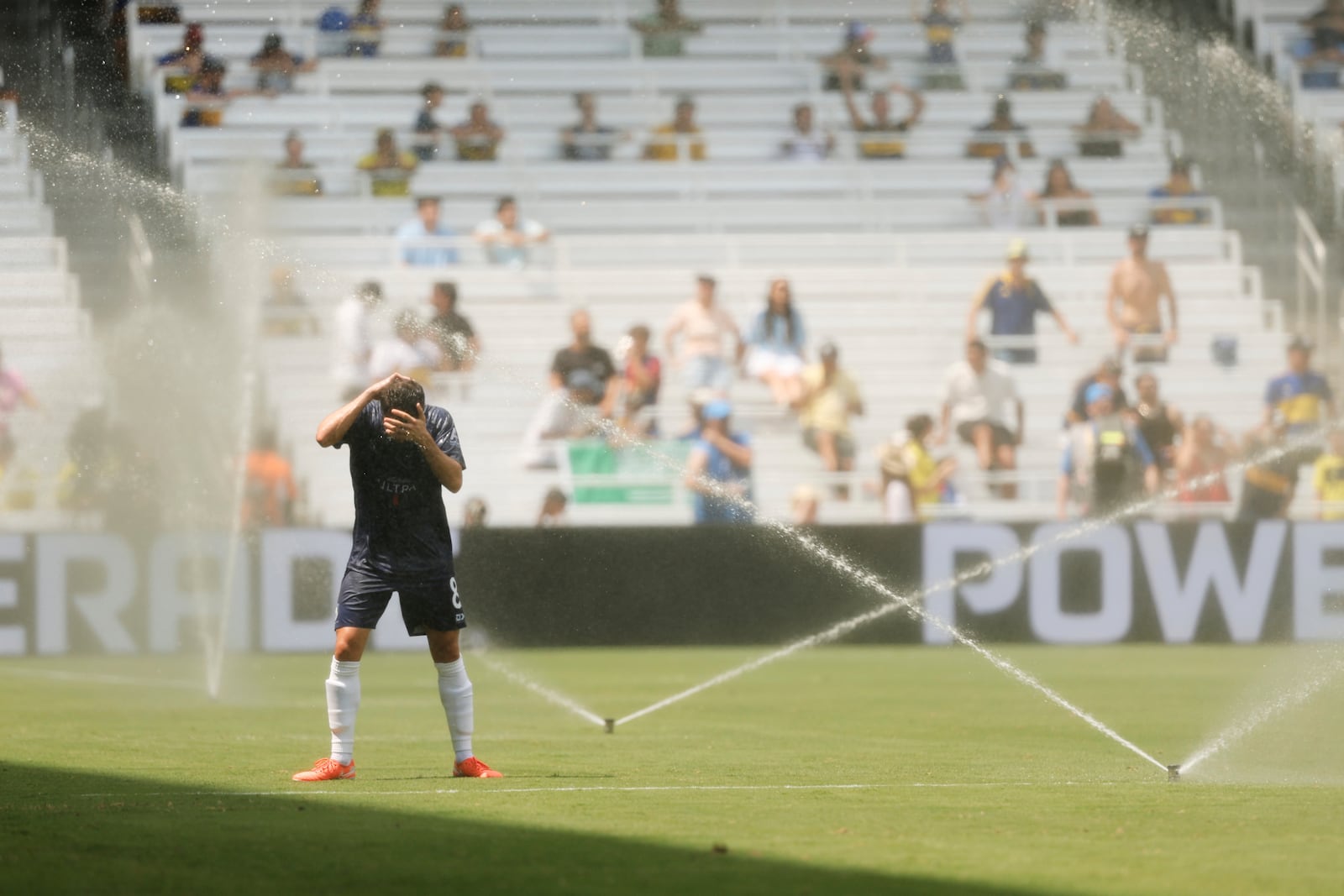 Auckland City's Gerard Garriga refreshes himself during the Club World Cup Group C soccer match between Auckland City and Boca Juniors in Nashville, Tenn., Tuesday, June 24, 2025. (AP Photo/Johnnie Izquierdo)