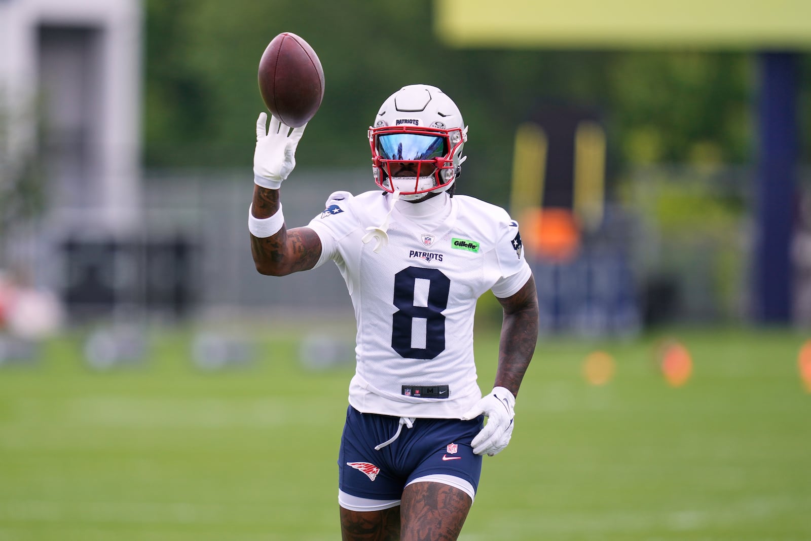 New England Patriots wide receiver Stefon Diggs tosses the ball after catching a pass during an NFL football practice, Monday, June 9, 2025, in Foxborough, Mass. (AP Photo/Charles Krupa)